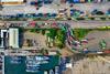 Birds eye view of lorries queuing at a transport hub near boats
