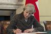 UK prime minister Theresa May signs the letter triggering Article 50
