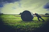 pushing back hay bale field
