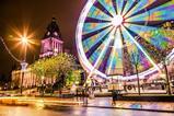 Long exposure photo of a ferris wheel next to a historical landmark in Leeds, England
