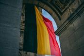 Belgian flag hanging down from a historical arch