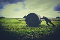 pushing back hay bale field