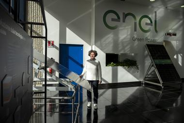 Enel's head of the advanced processes and materials characterization lab poses next to a state-of-the-art photovoltaic panel