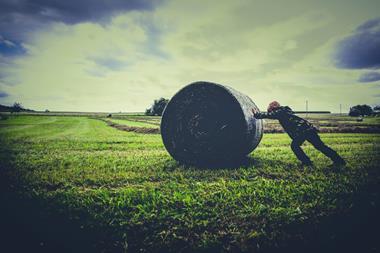 pushing back hay bale field