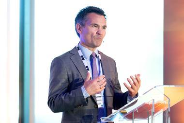 Photo of Rasmus Bessing delivering a speech behind a lectern at the 2026 IPE Transition conference