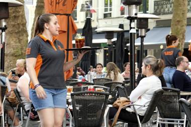 A waitress serves drinks on a terrace in the netherlands