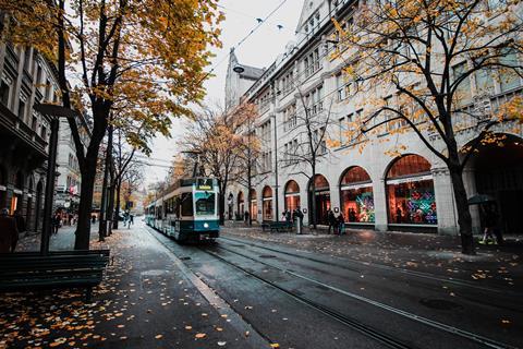 photo of tram passing through a Swiss city's shopping district