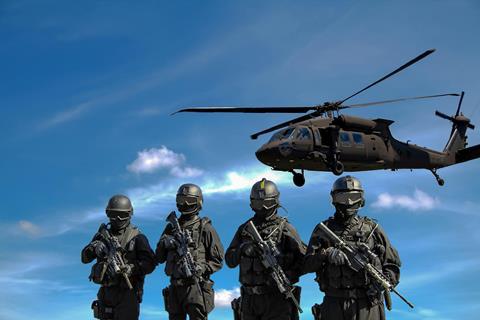 Four Soldiers Carrying Rifles Near Helicopter Under Blue Sky